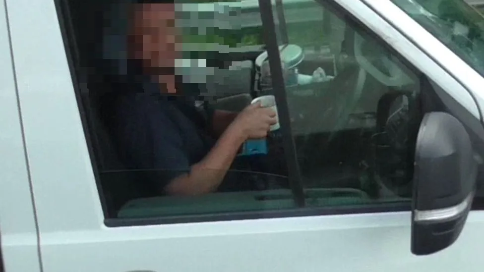 WATCH: Driver caught by police sipping mug of tea and removing both hands from wheel